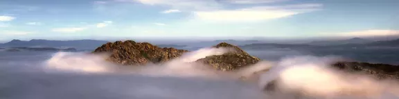 mountain tops amidst clouds