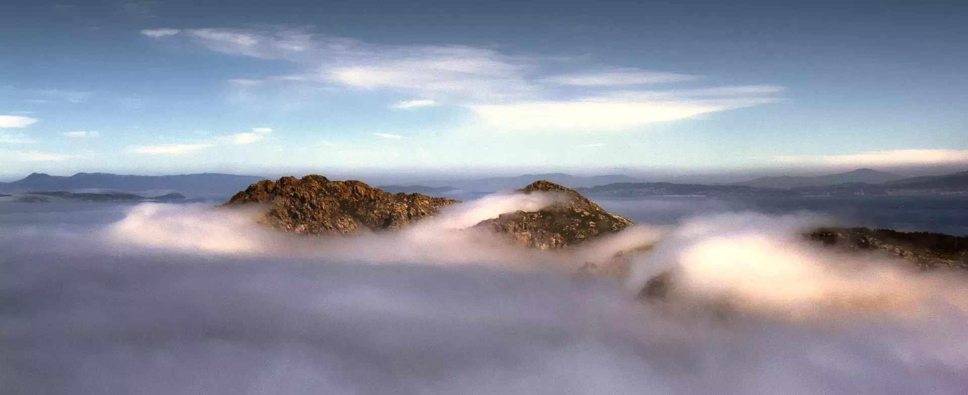 mountain tops amidst clouds